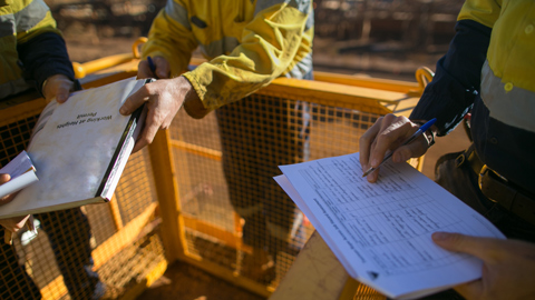 supervisor checking review document before issued, working at height permit and risk assessment on construction site