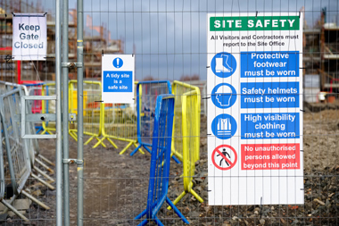 construction site health and safety message rules and sign board on fence